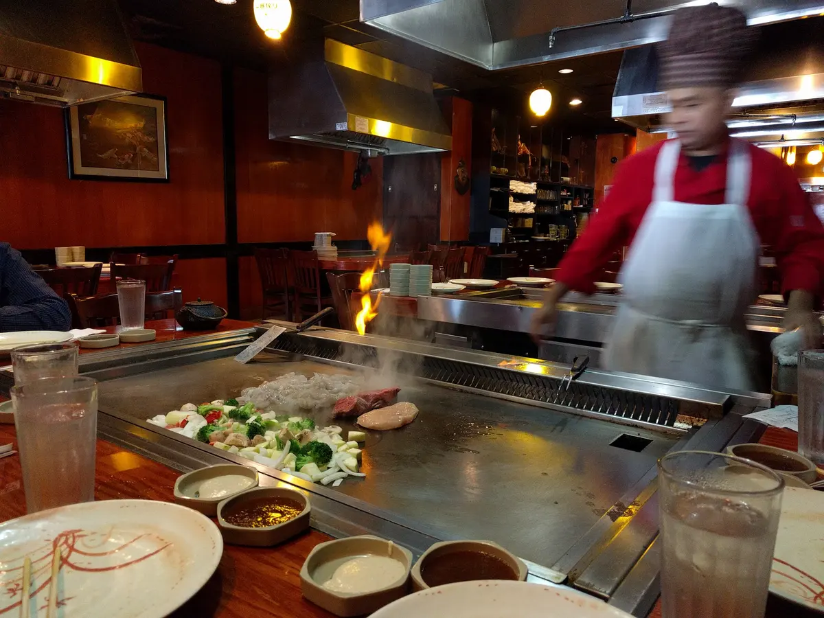 Chef at the hibachi grill with guests at Abis in Greenwich